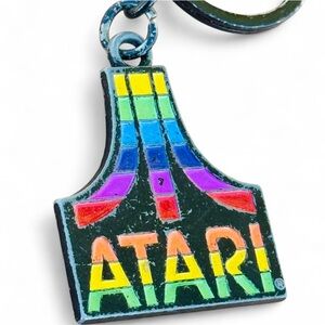 Vintage Multicolored Atari Keychain on Black Background